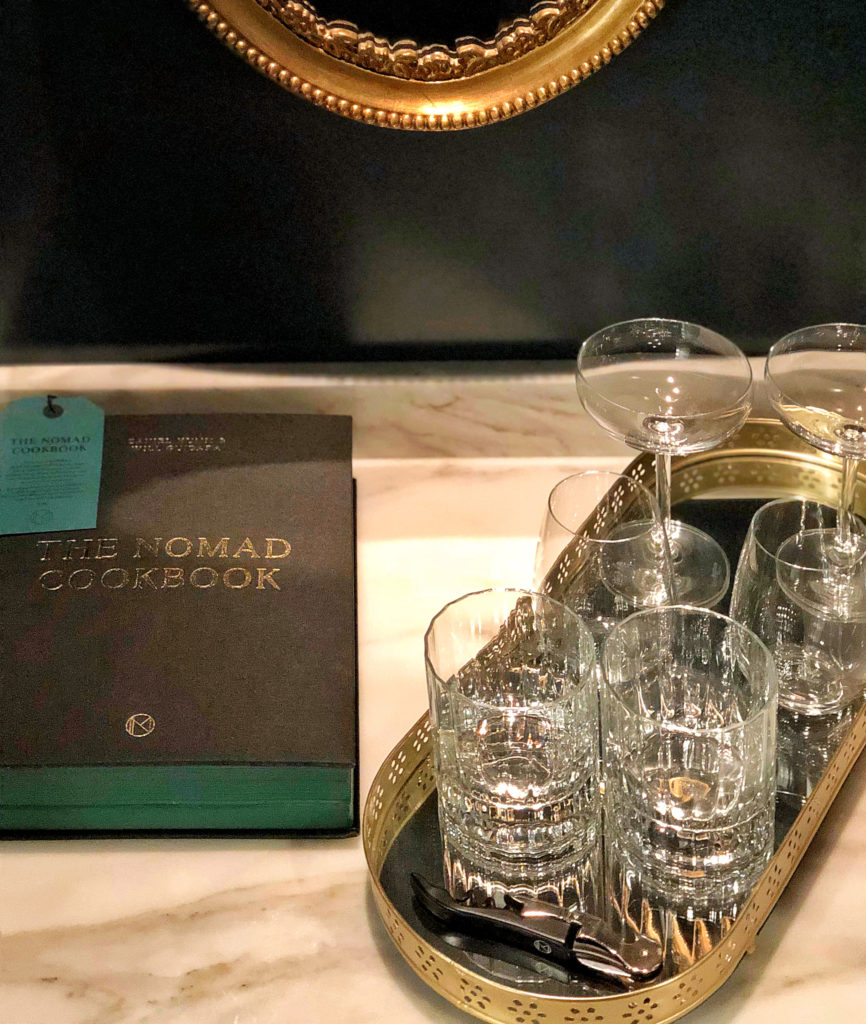 Minibar display details with cut crystal glassware on mirrored tray at the Nomad Hotel, Los Angeles.