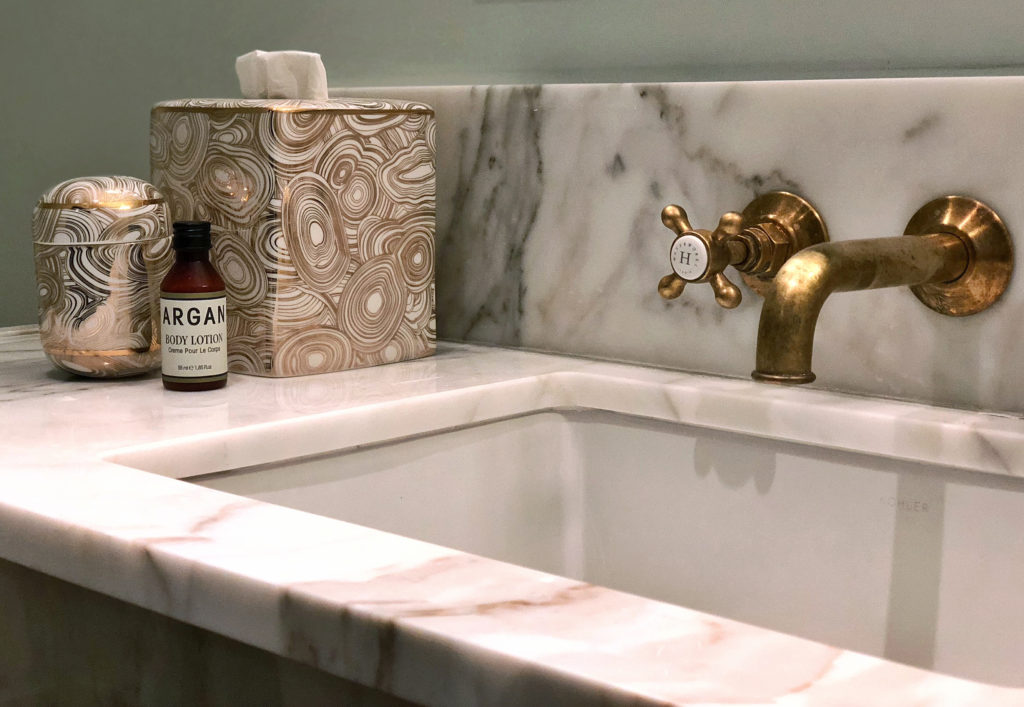 New traditional interior design style - Marble sink and vanity with gold decorative accessories in the bathroom at the Nomad hotel, Los Angeles