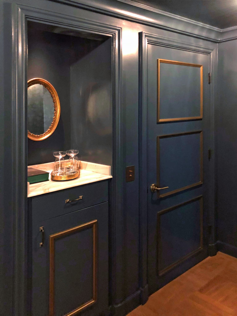 New traditional interior design style - Mini bar within the foyer entry painted in marine green at the Nomad guest room, Los Angeles.