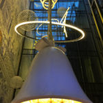 Hanging bell from atrium in Andaz hotel in Amsterdam creates a whimsical interior design style.