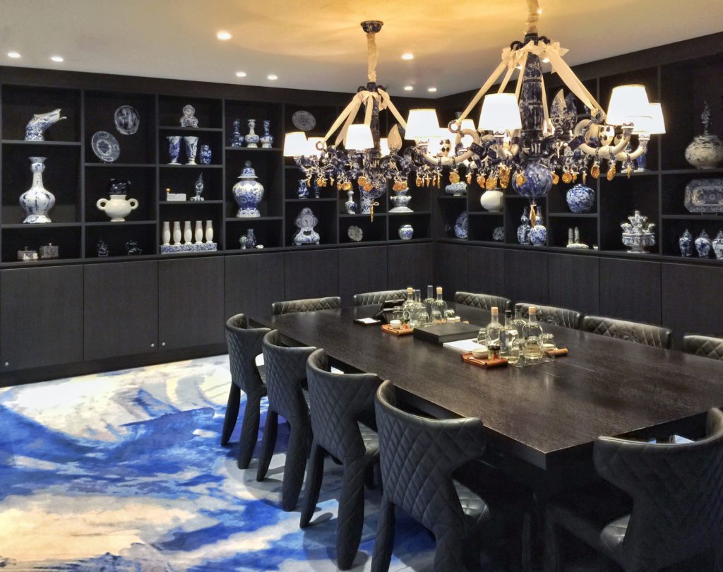 Delft blue interior design accessories on shelves at the Andaz hotel in Amsterdam.