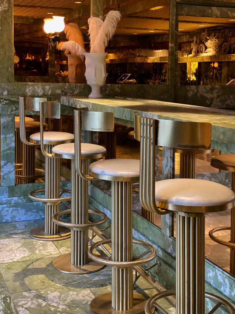 Deco design details with brushed brass barstools inside Mini Bar at the Parker Palm Springs Hotel.