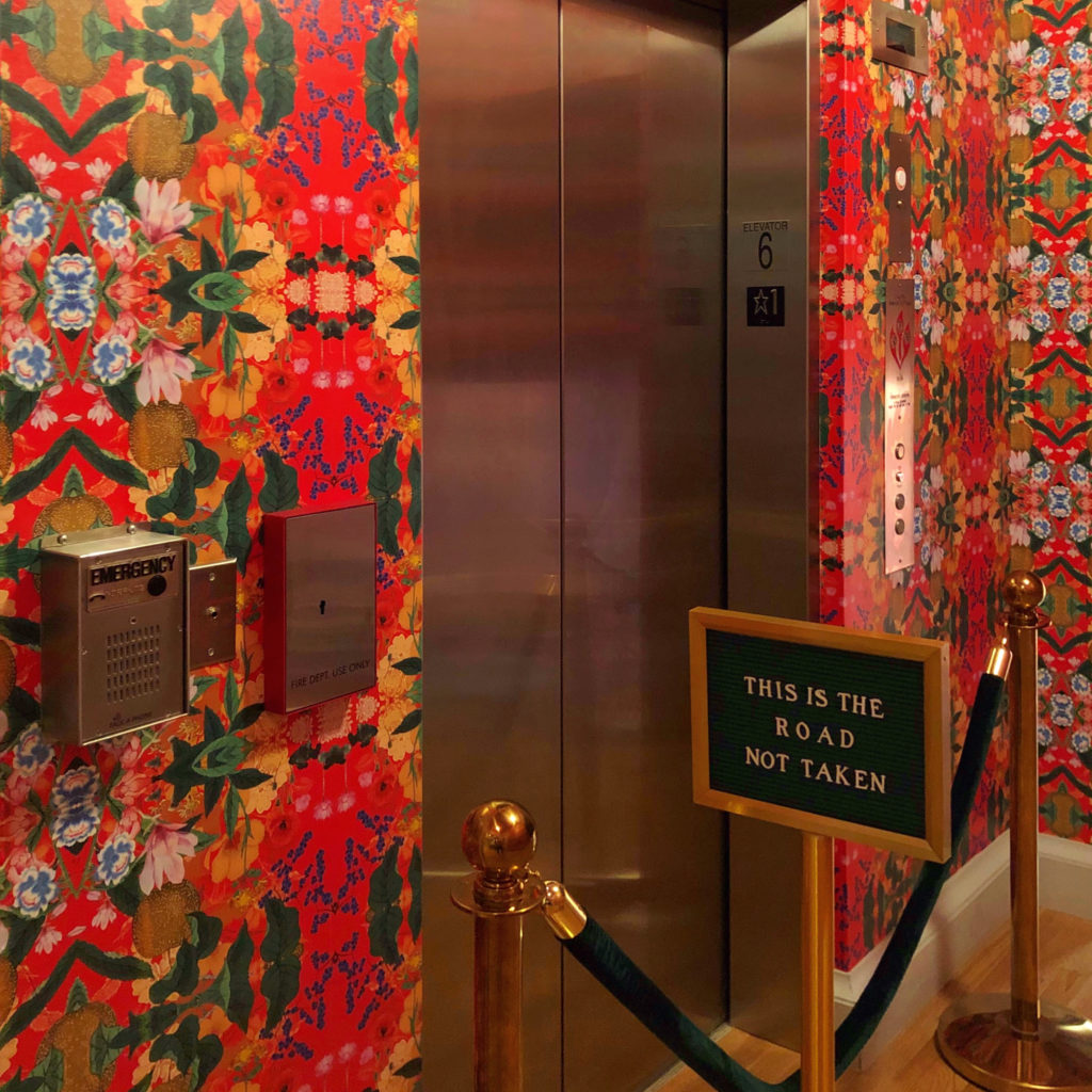 Whimsical, eclectic interior design wallpaper at elevator with witty signage. The Line Hotel, Washington, DC.