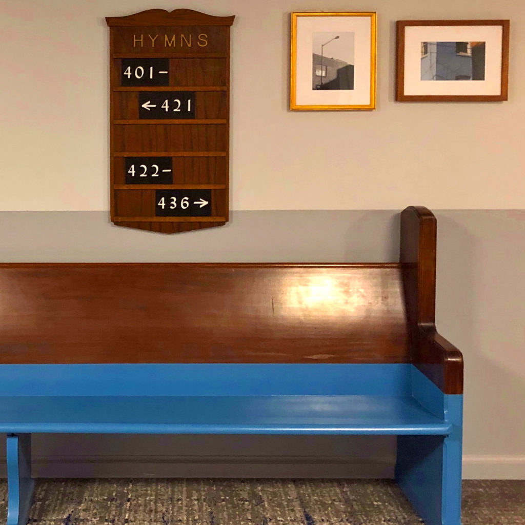 Witty and eclectic interior design expressions with color-blocked church pew and hymnal-inspired room signage at the Line Hotel, Washington DC.