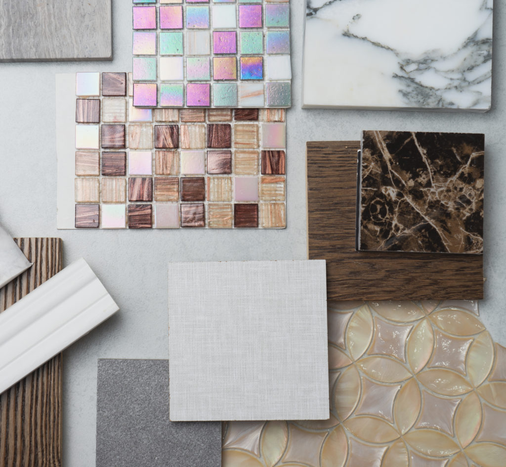Luxe interior finishes and materials including stone, marble, and tile samples.