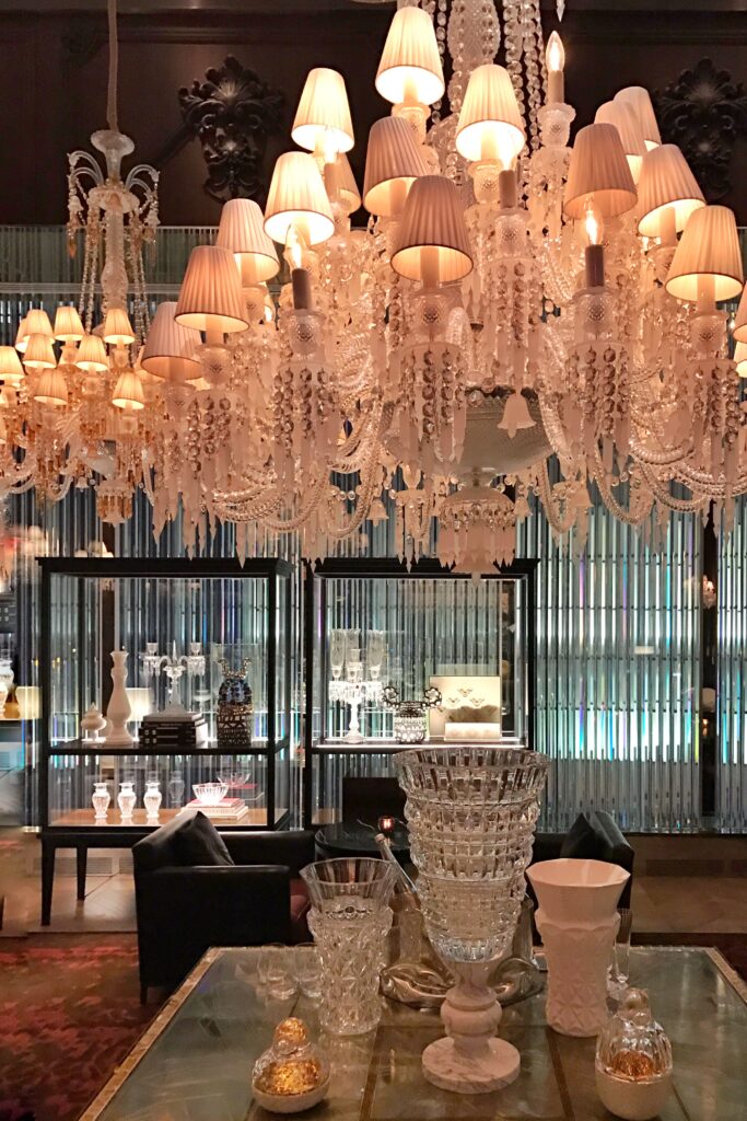 Aesthetic Travel Guide to New York City - Baccarat hanging crystal chandeliers and cut crystal on display.