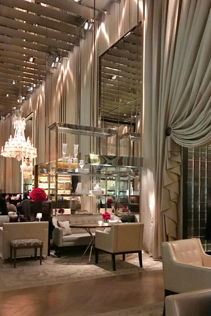 Walls of draped fabric surround the Grand Salon at the High Tea Experience at the Baccarat Hotel in New York City.