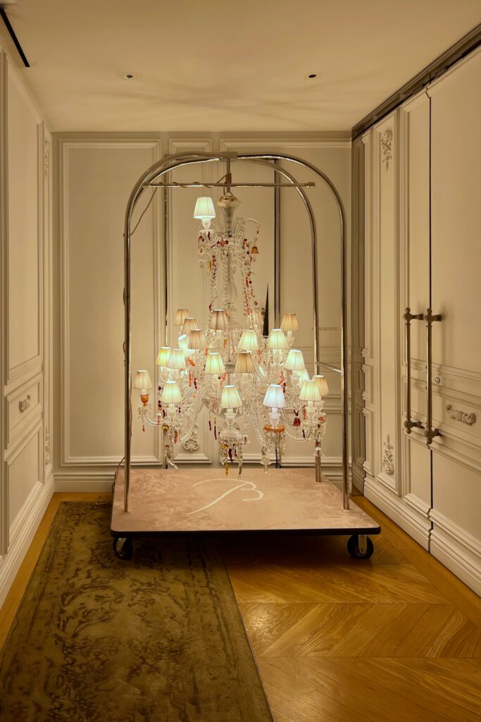 Aesthetic Travel Guide to New York City - Baccarat Hotel chandelier hanging on rolling luggage cart.