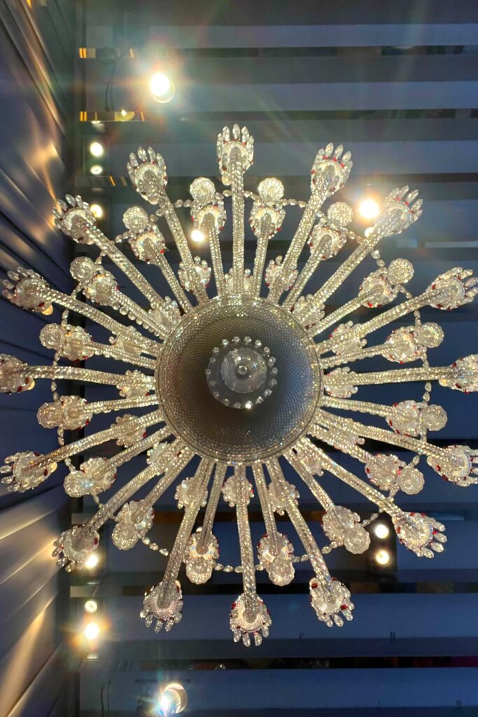 View looking up at a crystal chandelier in the Grand Salon of the Baccarat Hotel in New York City.