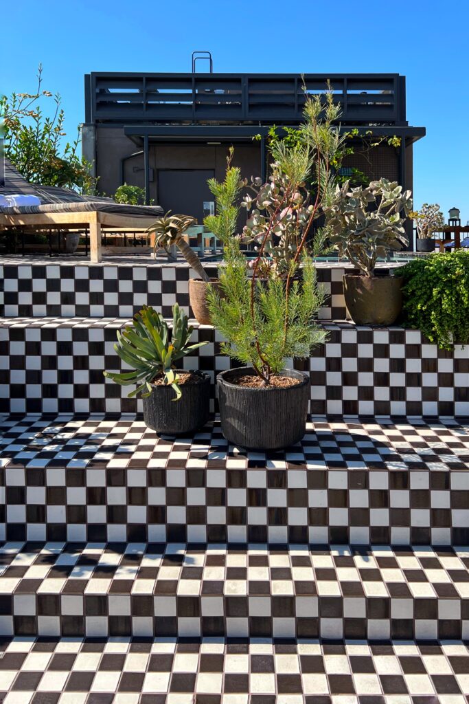 Luxury hotel in dowtown Los Angeles - black and white stepped checkerboard tile on the rooftop pool deck at the Proper Hotel.
