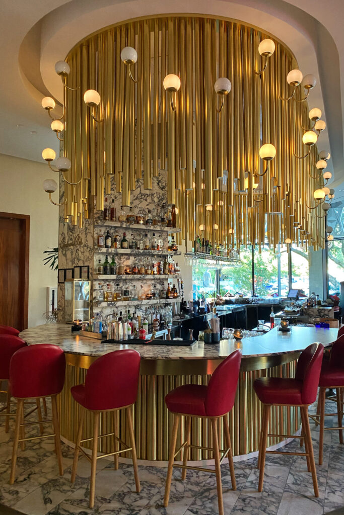 Brass fluted interior design details at the curved Virgin Hotel bar in Dallas, Texas.