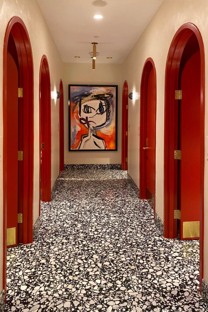 Dopamine Decor interior design details with the red arched restroom doors at the Virgin Hotel in Dallas.