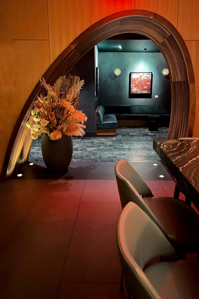 The off-center arched doorway leading to the dining area inside Restuarant 53, one of New York City's most aesthetic spaces.