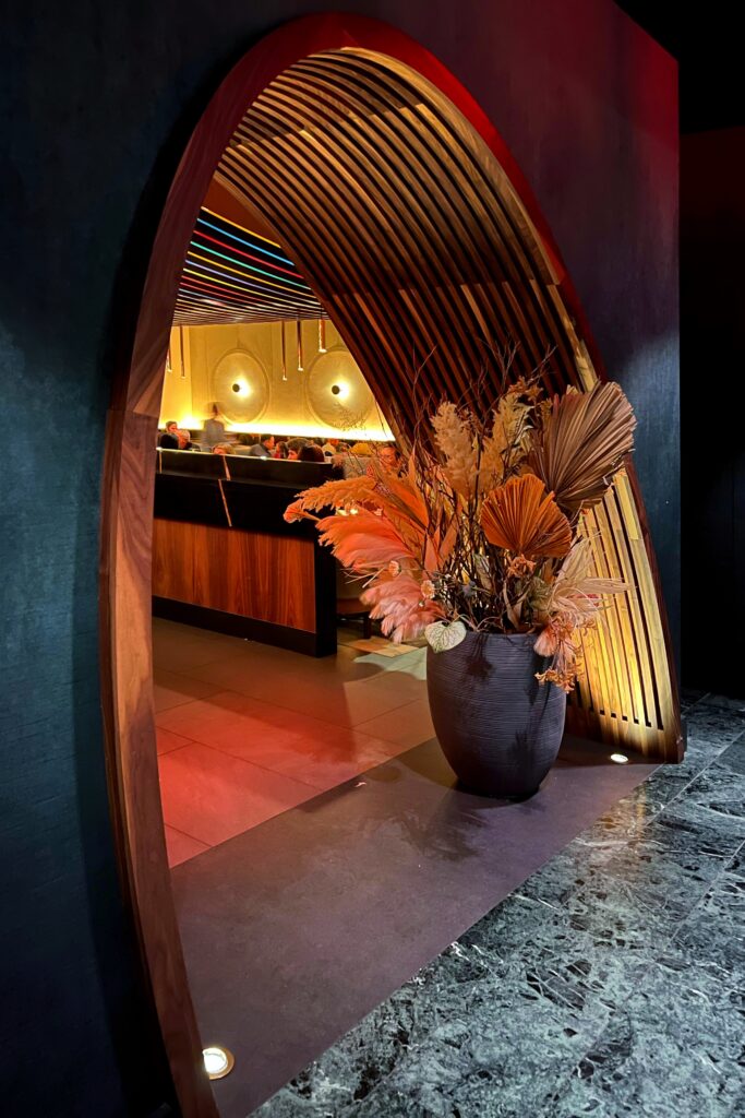 Aesthetic Travel Guide to New York City - Restaurant 53, arched opening with large floral display.