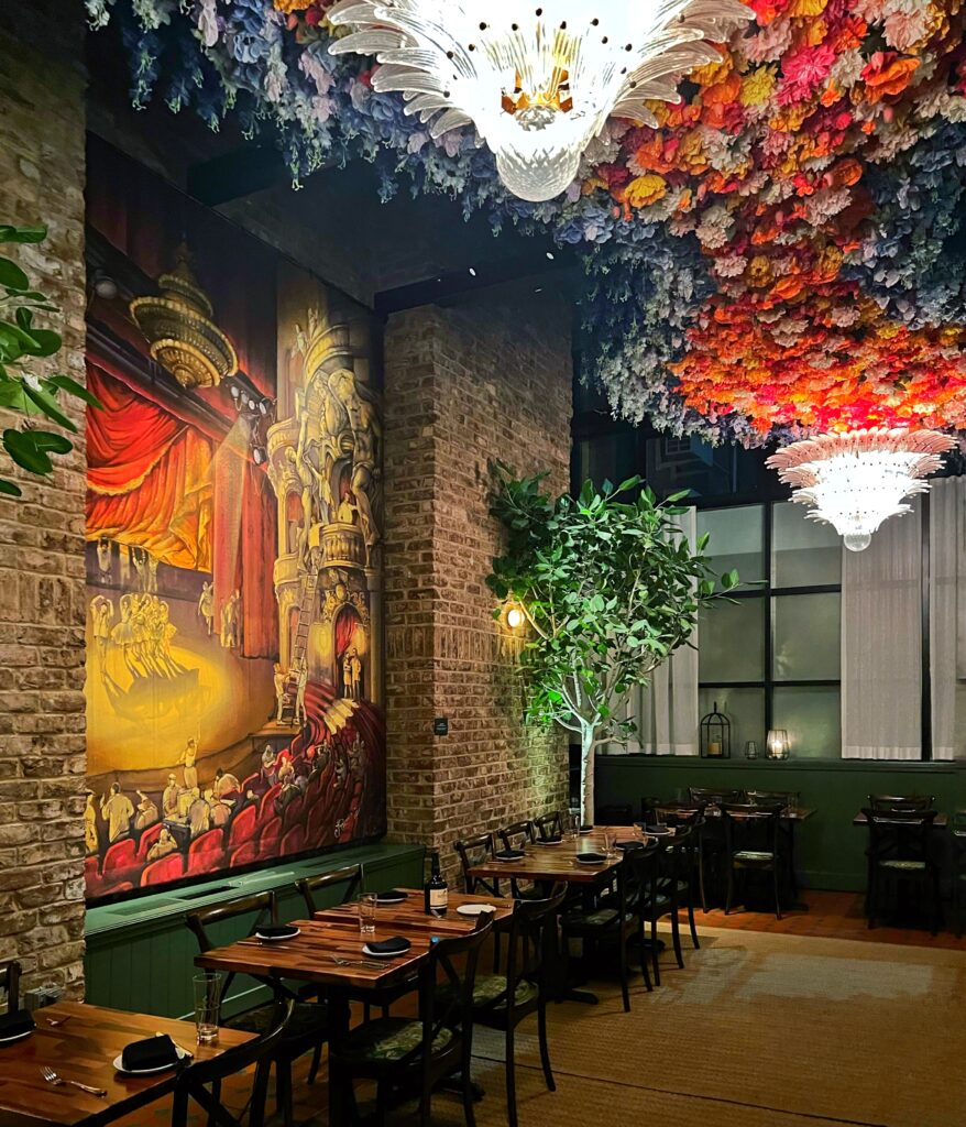 Floral ceiling and chandeliers inside the Secret Garden Rosevale Restaurant inside the Civilian Hotel, one of New York City's most aesthetic spaces.