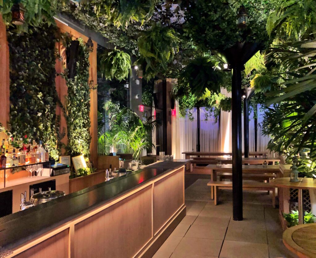 View of the lush botanical biophilic plants inside the bar at the Edition Hotel in New York City.