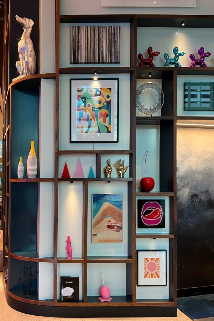 Quirky and whimsical styled shelves inside the lobby of the Wave Hotel in Orlando, Florida. Shelf styling inspired by luxury hotels.