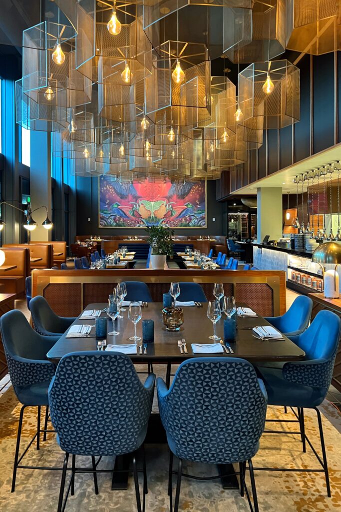 View inside the restaurant with hanging chandeliers inside the Wave Hotel in Orlando, Florida. Shelf styling inspired by luxury hotels.