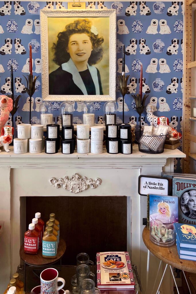 Golden Slipper retail boutique in Nashville with playful dog-print wallpaper, vintage portrait, vintage fireplace, candles, and Dolly Parton books — a must-visit spot in the Nashville Aesthetic Travel Guide.