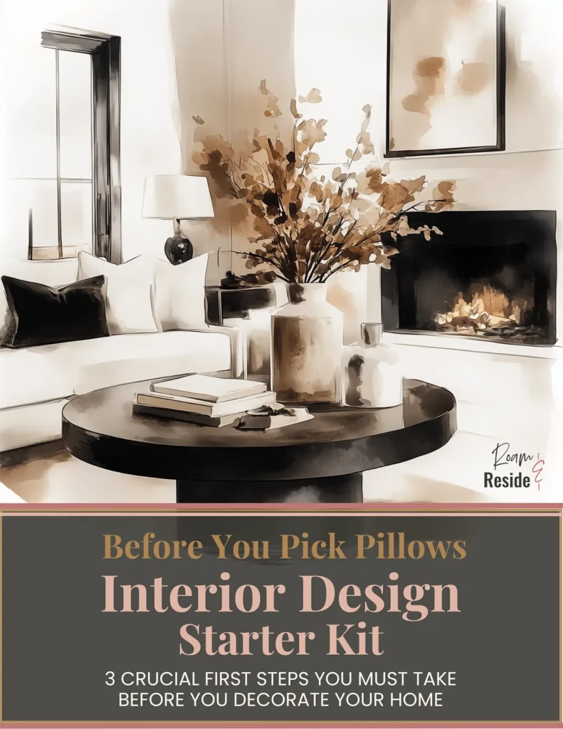 Interior Design Starter Kit digital guide cover displayed on tablet, featuring a modern neutral living room with cozy sofa, black accent pillows, round coffee table, fireplace, and styled florals — promoting ‘Before You Pick Pillows: 3 Crucial First Steps You Must Take Before You Decorate Your Home.