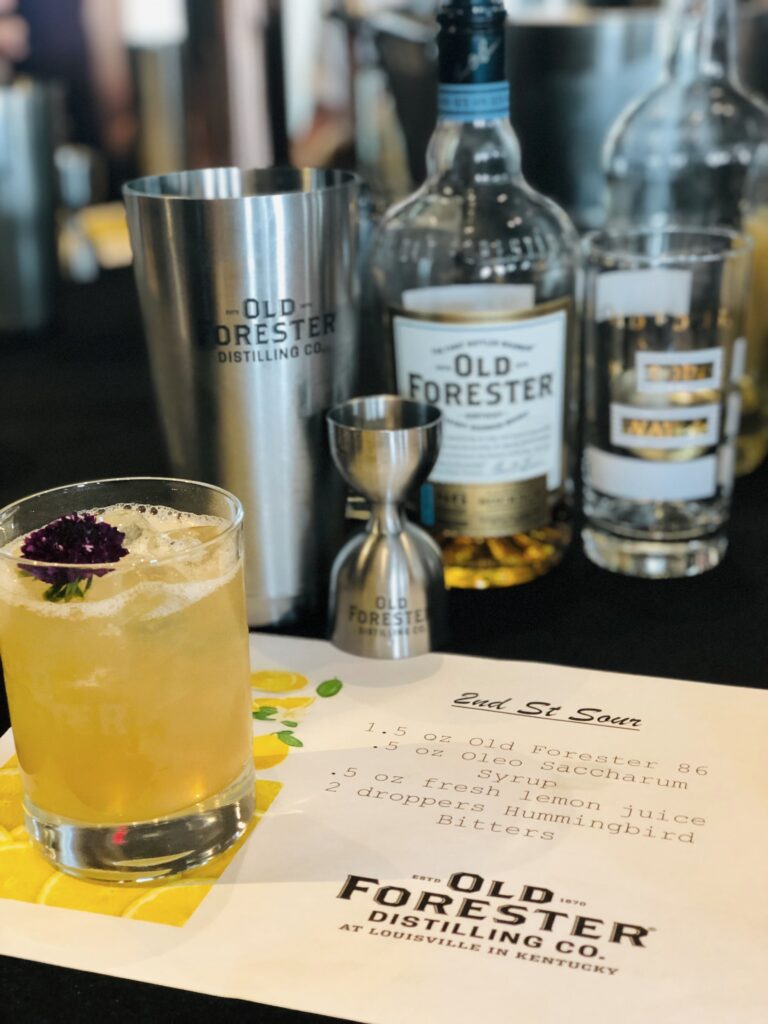 2nd St Sour cocktail at Old Forester Distilling Co. in Louisville, Kentucky, served beside an Old Forester bourbon bottle, shaker, jigger, and printed recipe card.